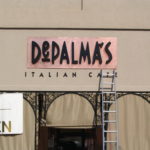 Restaurant sign using custom lettering and metal