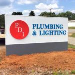 Roadside monument sign for plumbing and lighting business