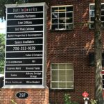 Large monument sign listing multiple businesses in Athens, GA